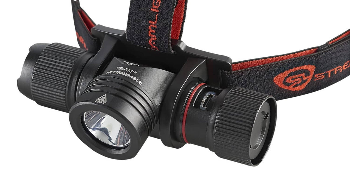 Streamlight black headlamp side view with front lens, control knobs, orange strap logo