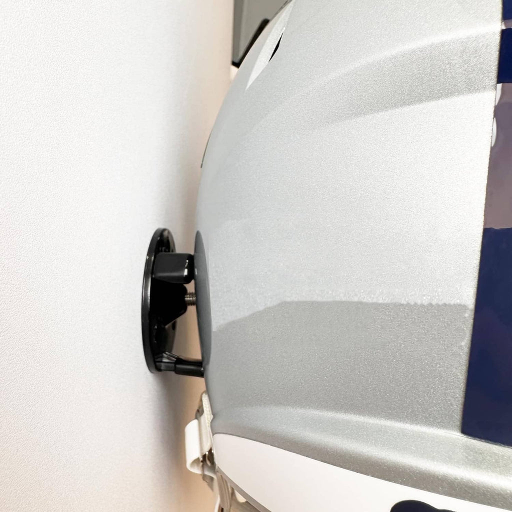 Gray football helmet with black wall mount bracket attached for hanging display