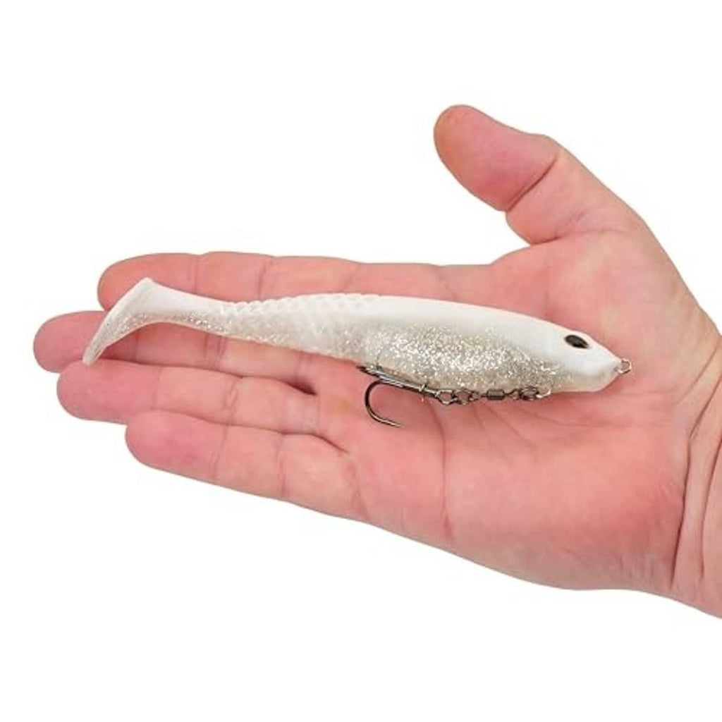 Soft plastic swimbait lure held in hand, translucent white with glitter and treble hook