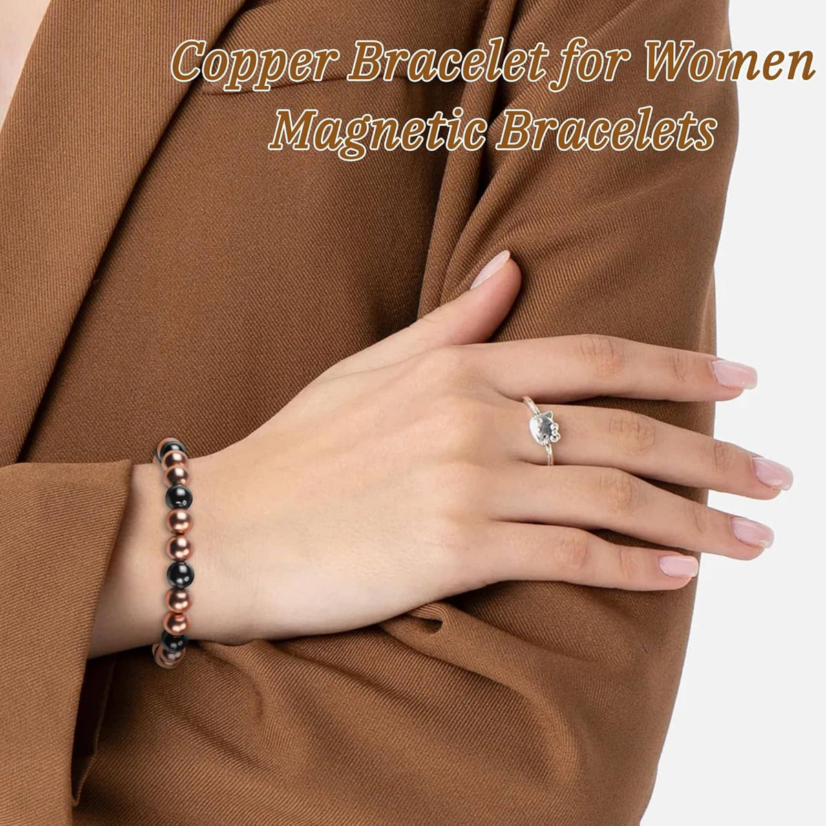 Copper and black magnetic beaded bracelet on wrist with sleeve cuff visible