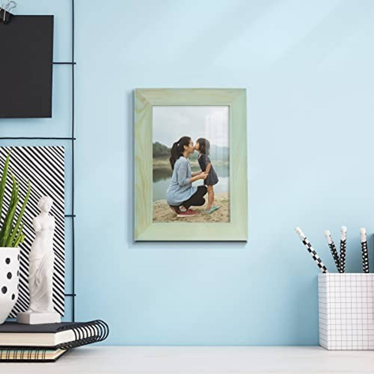 Seafoam green 4x6 picture frame displayed on a wall with photo inside