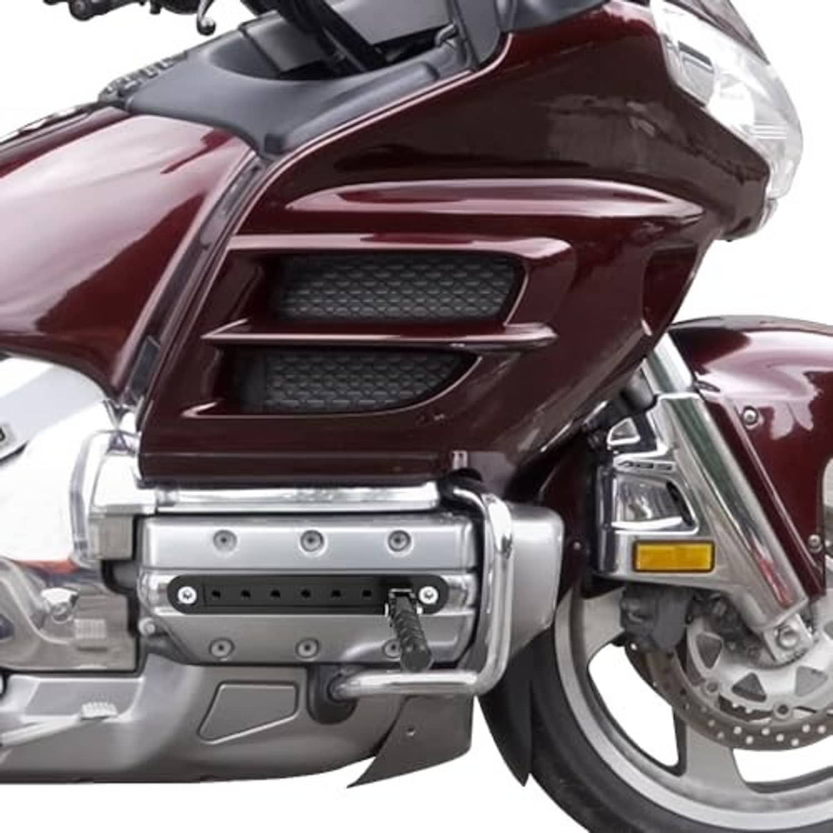 Installed highway peg mount on motorcycle with perforated black bar