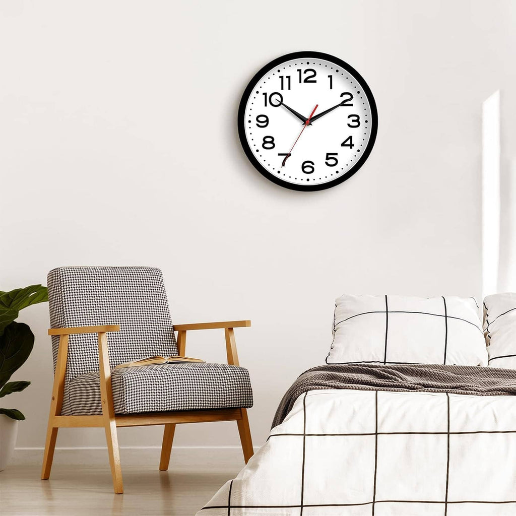 Wall clock with black rim, white dial, bold numerals, and red second hand