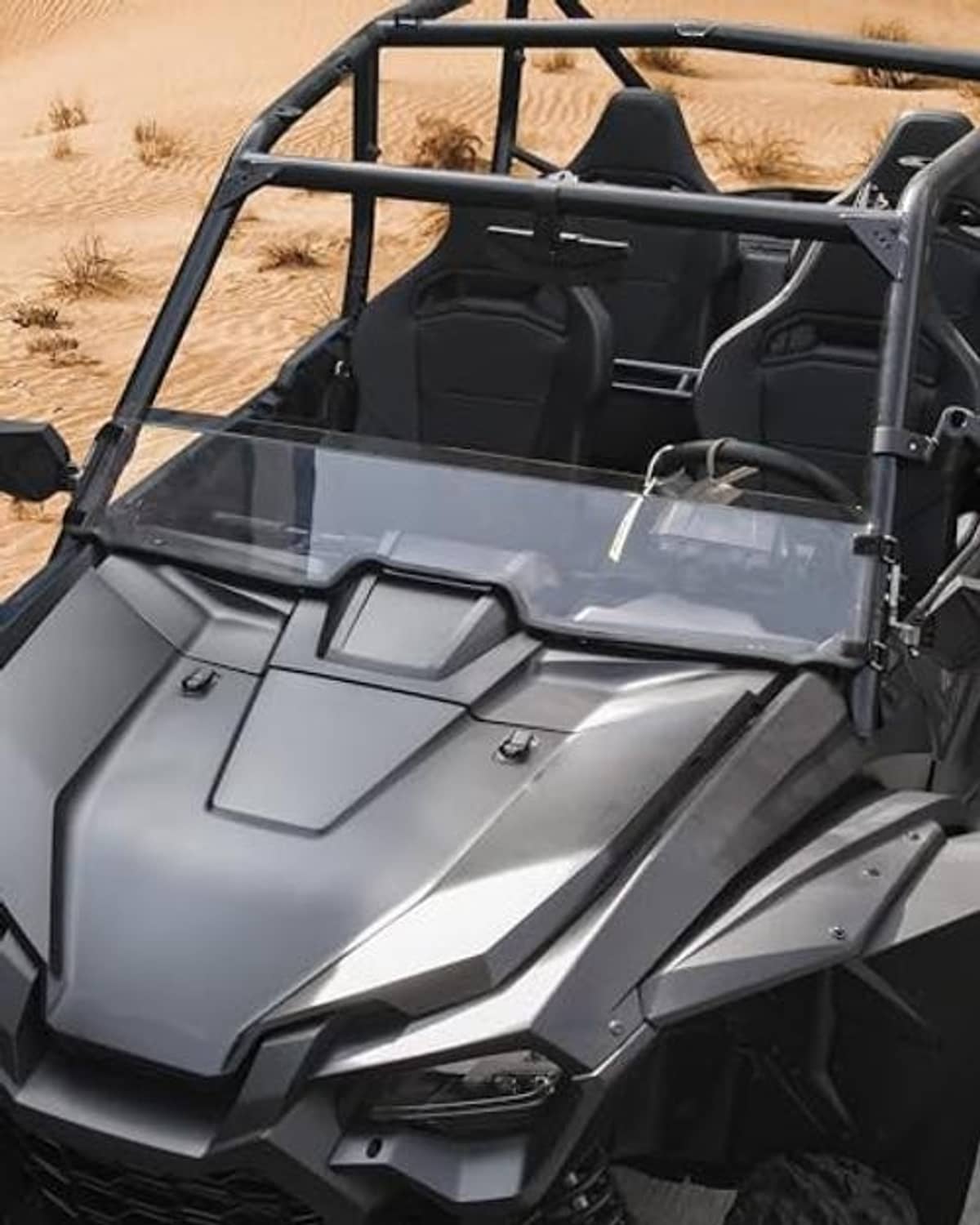 Clear half windshield panel with black frame on gray UTV