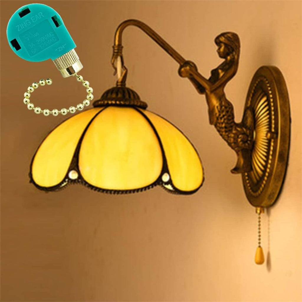 Ceiling fan pull chain switch with teal housing and brass bead chain on a wall light