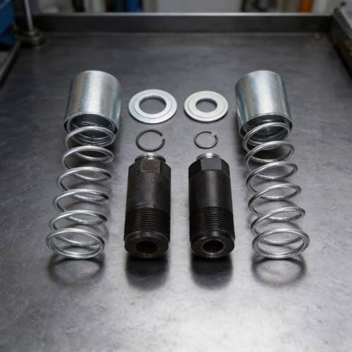 Hydraulic jack rebuild kit: pair of black cylinders with silver coil springs and washers