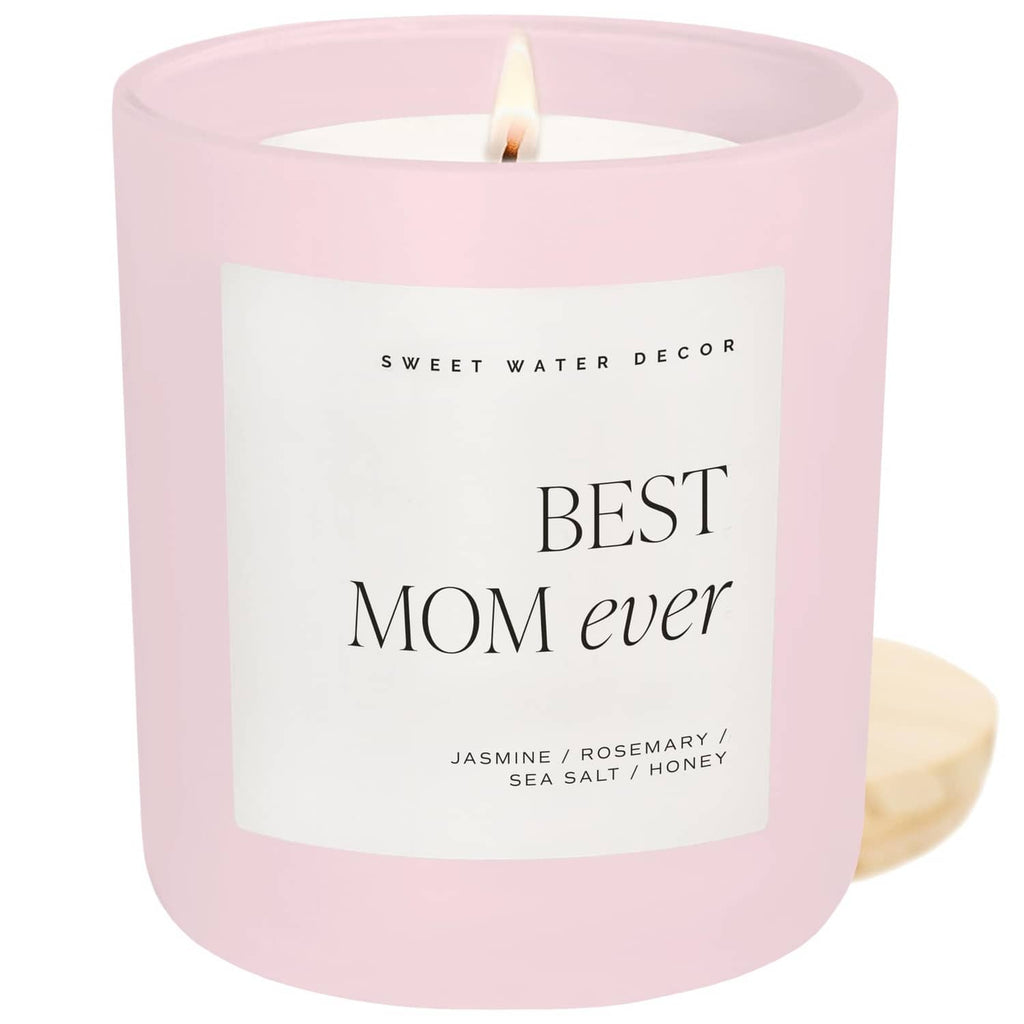Pink soy jar scented candle with “Best Mom ever” label and unlit wick