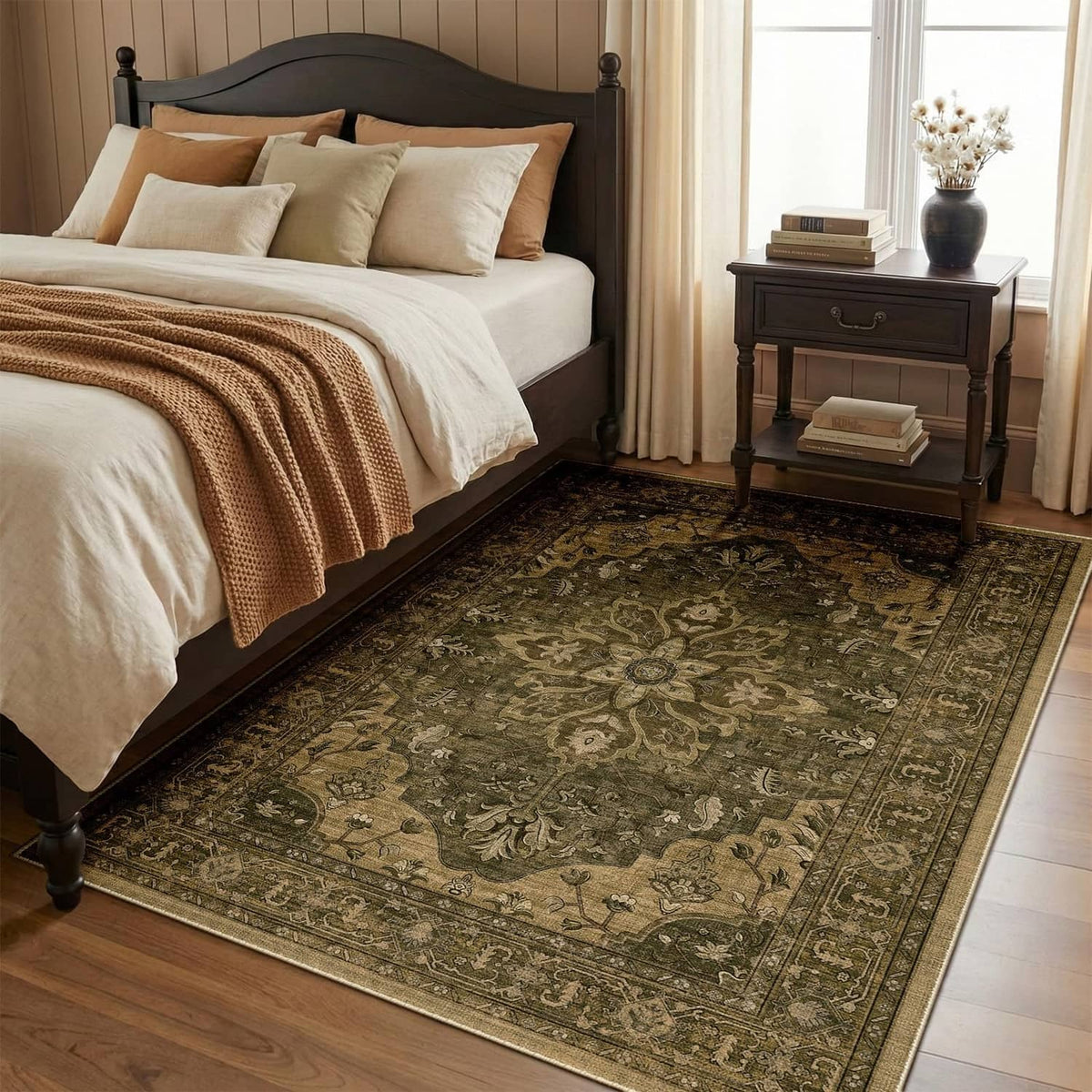 Rectangular area rug with dark green ornate medallion pattern, textured low pile