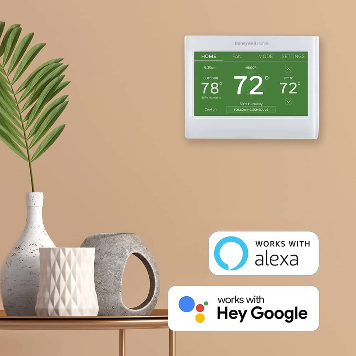 White smart color thermostat with green touchscreen, plus Alexa and Hey Google icons.