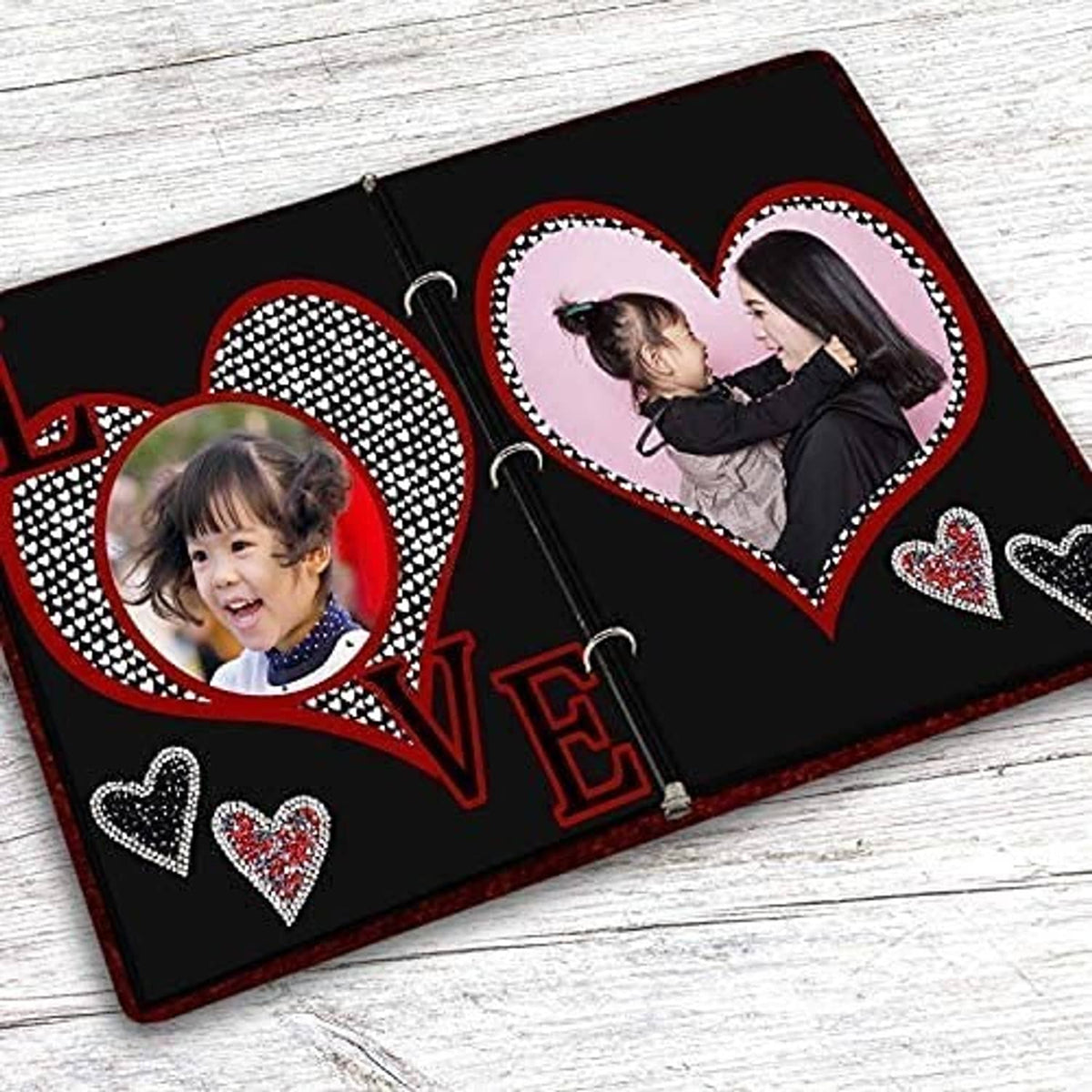 Black photo album cover with heart cutouts and 'LOVE' photo frames
