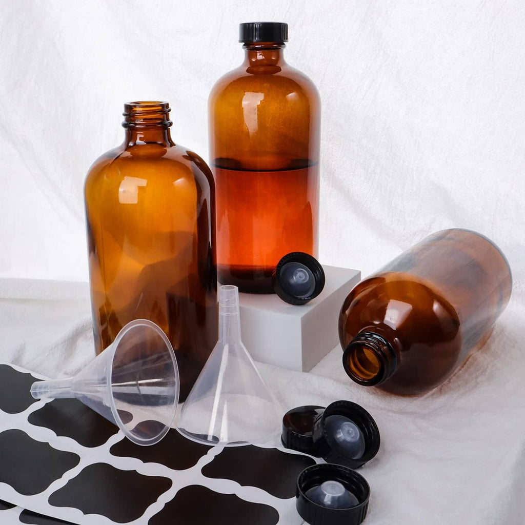 Amber glass bottles with black caps with funnels and bottle pour spout caps.