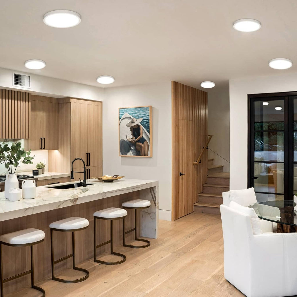 White LED flush mount ceiling lights with slim round housings in a modern room