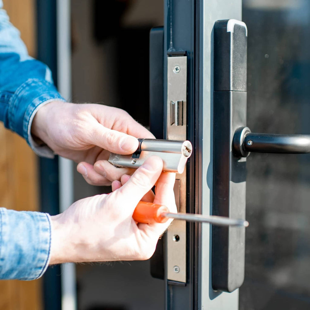 Brass cylinder lock being opened with a key on a door