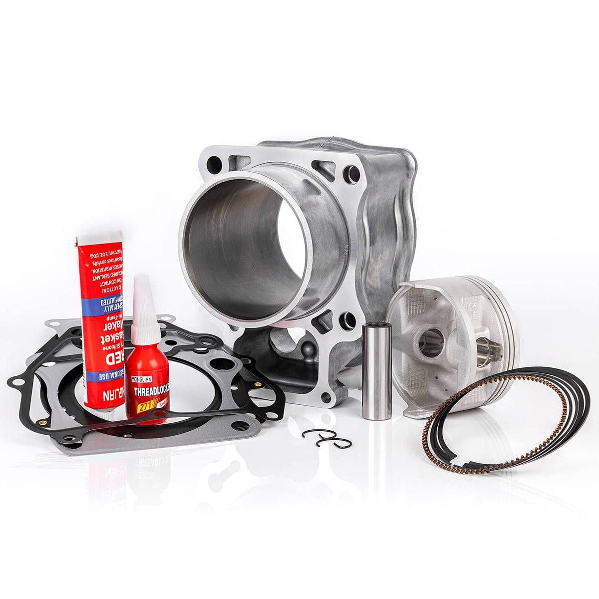 Engine rebuild kit in full set: silver cylinder, piston, rings, black gaskets, and red sealant tube