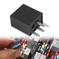 Black 4-pin headlight relay with three blade terminals, close-up view
