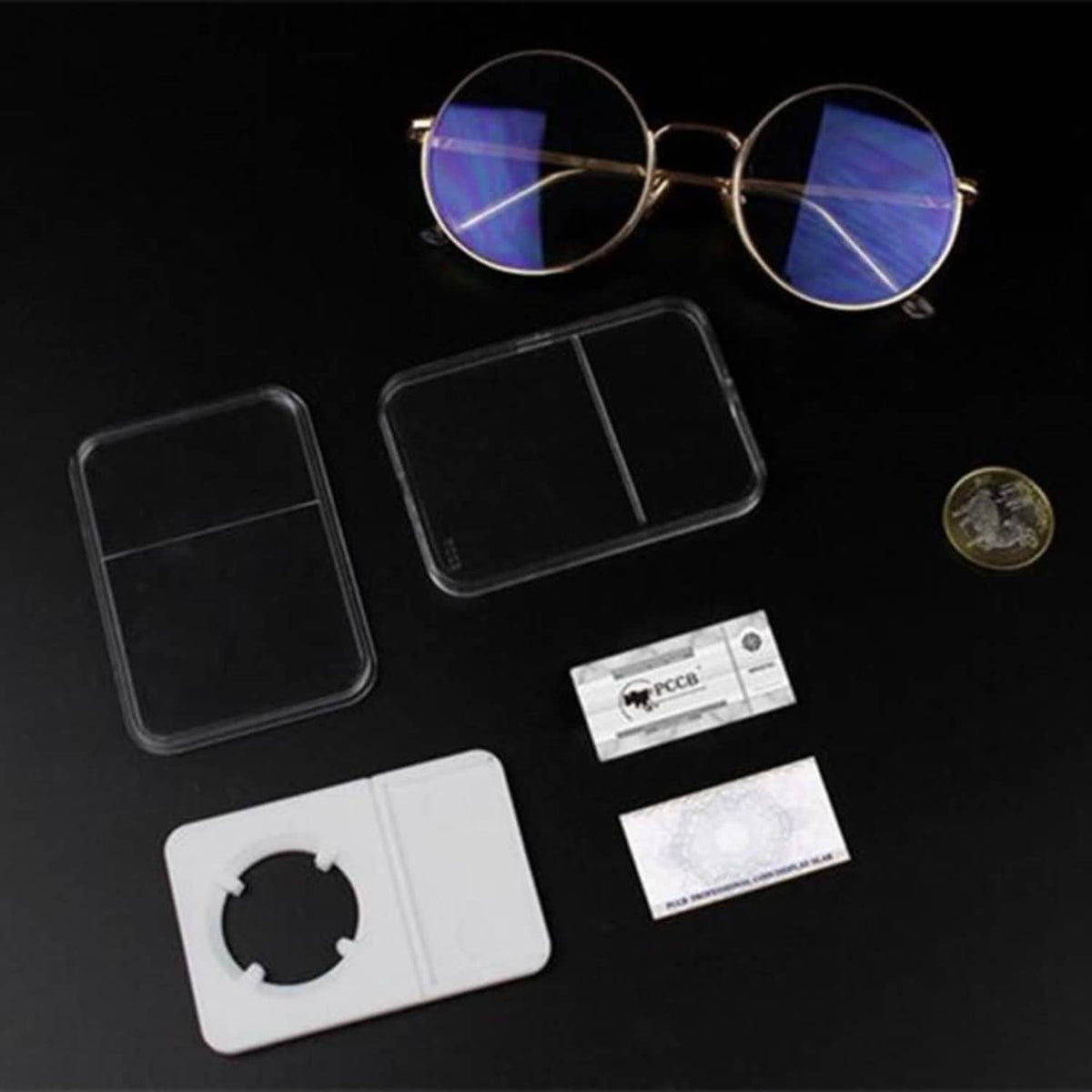 Acrylic coin slab holders set with circular cutouts, cards, and small coin