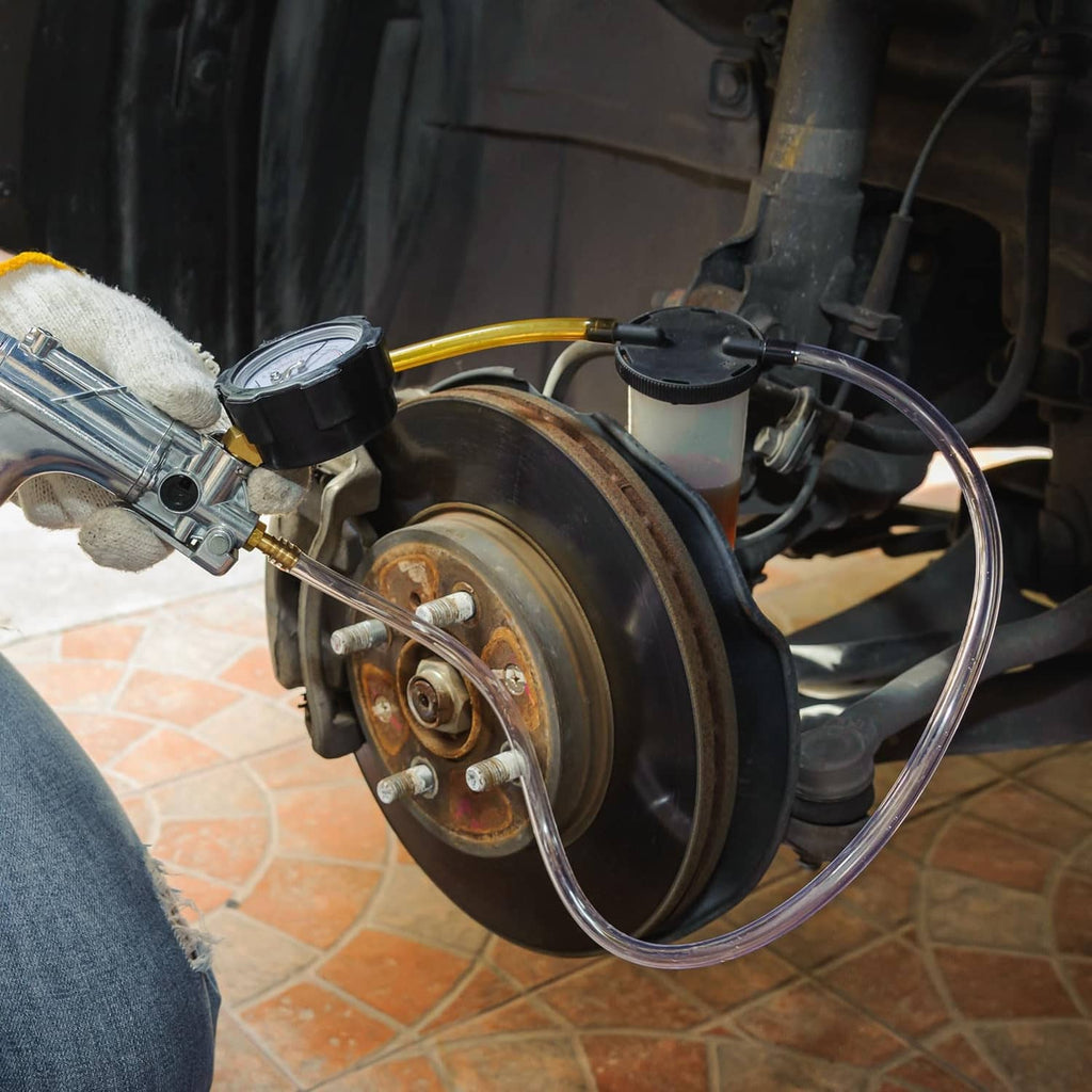 Transparent tubing connected near an automotive wheel and brake assembly