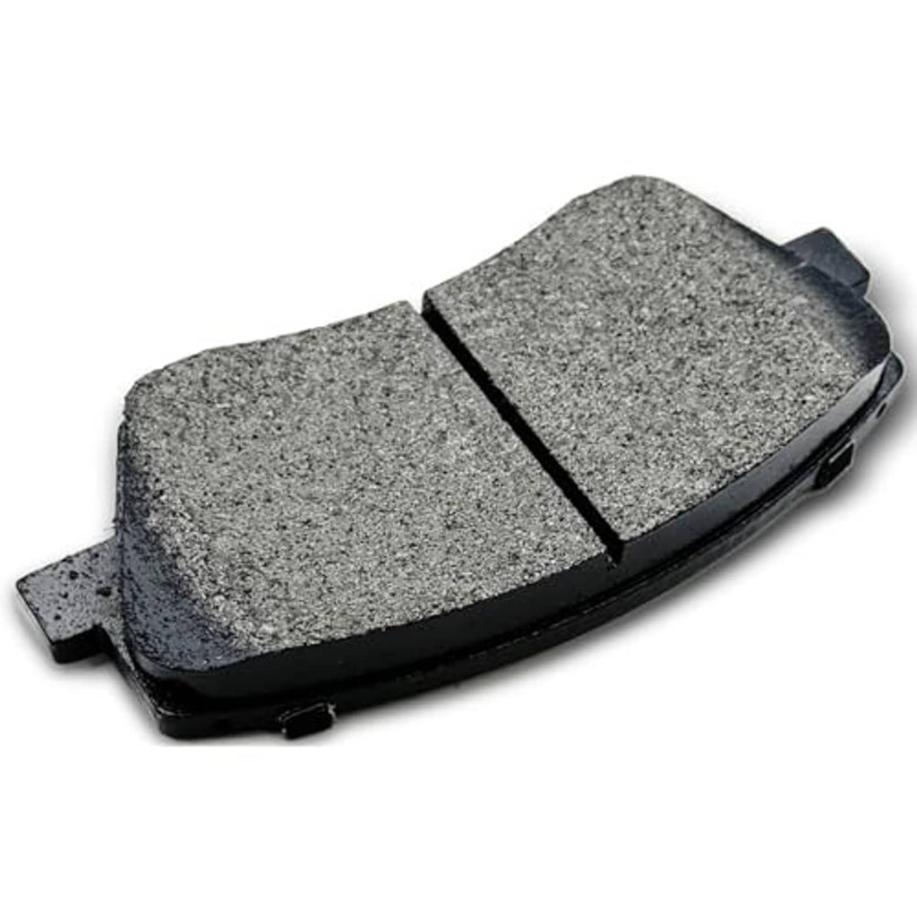 Gray ceramic brake pad with black backing and side tabs, close angle view