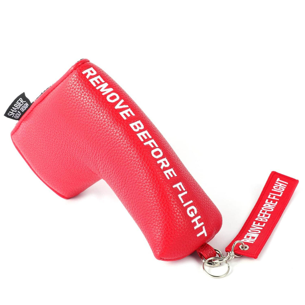 Red blade-style golf putter cover with "Remove Before Flight" keychain tag