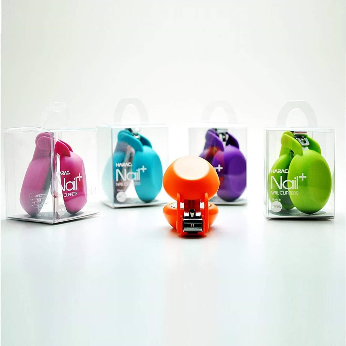 Packaged nail clippers in multiple colors, including purple and green