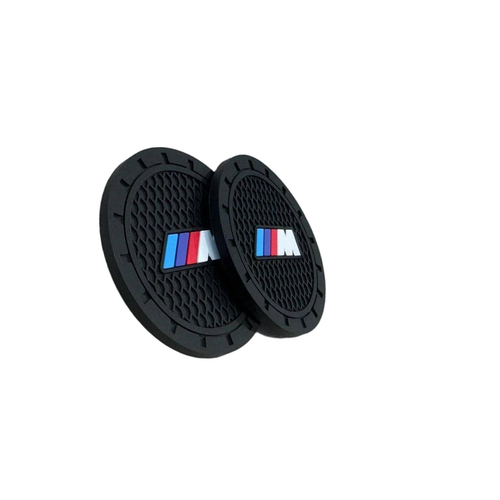 Black round car cup holder coaster set with raised texture and BMW M logo, pair view