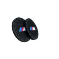 Black round car cup holder coaster set with raised texture and BMW M logo, pair view