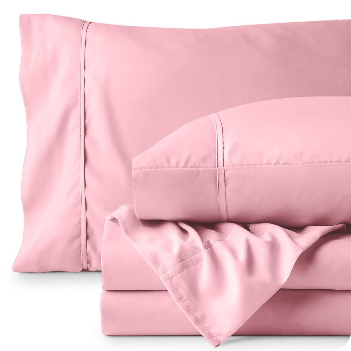 Light pink pillowcases and folded flat sheet with stitched edges and smooth fabric