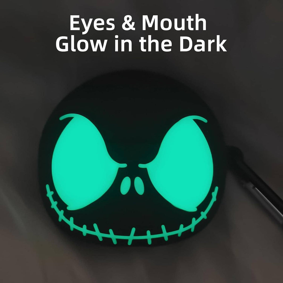 Black earbuds case cover showing glowing green eyes and mouth detail in dark look
