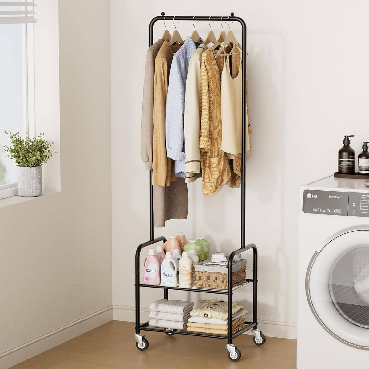 Black metal rolling clothes rack with hanging bar and two shelves, towels and bottles