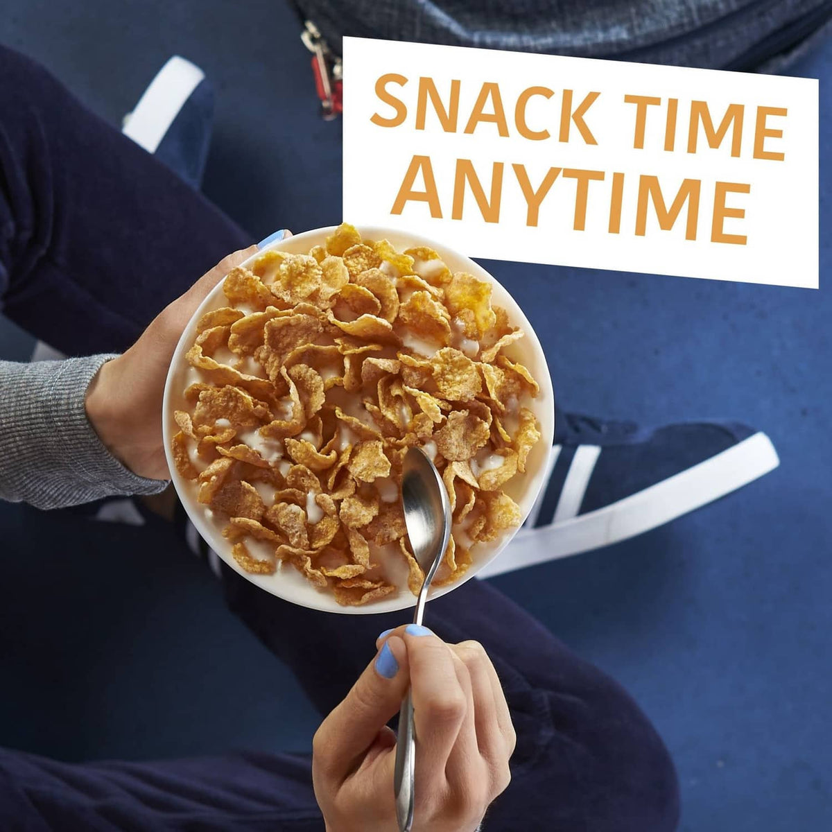 Cornflakes bowl with spoon, 'Snack time anytime' banner, handheld breakfast cereal