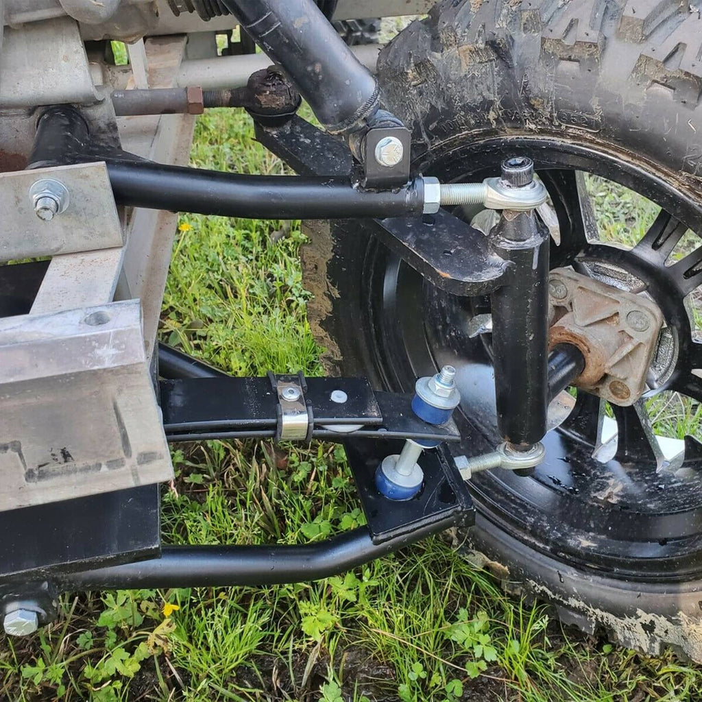 Installed lift components near the rear wheel: black arms, spring hardware, and brackets