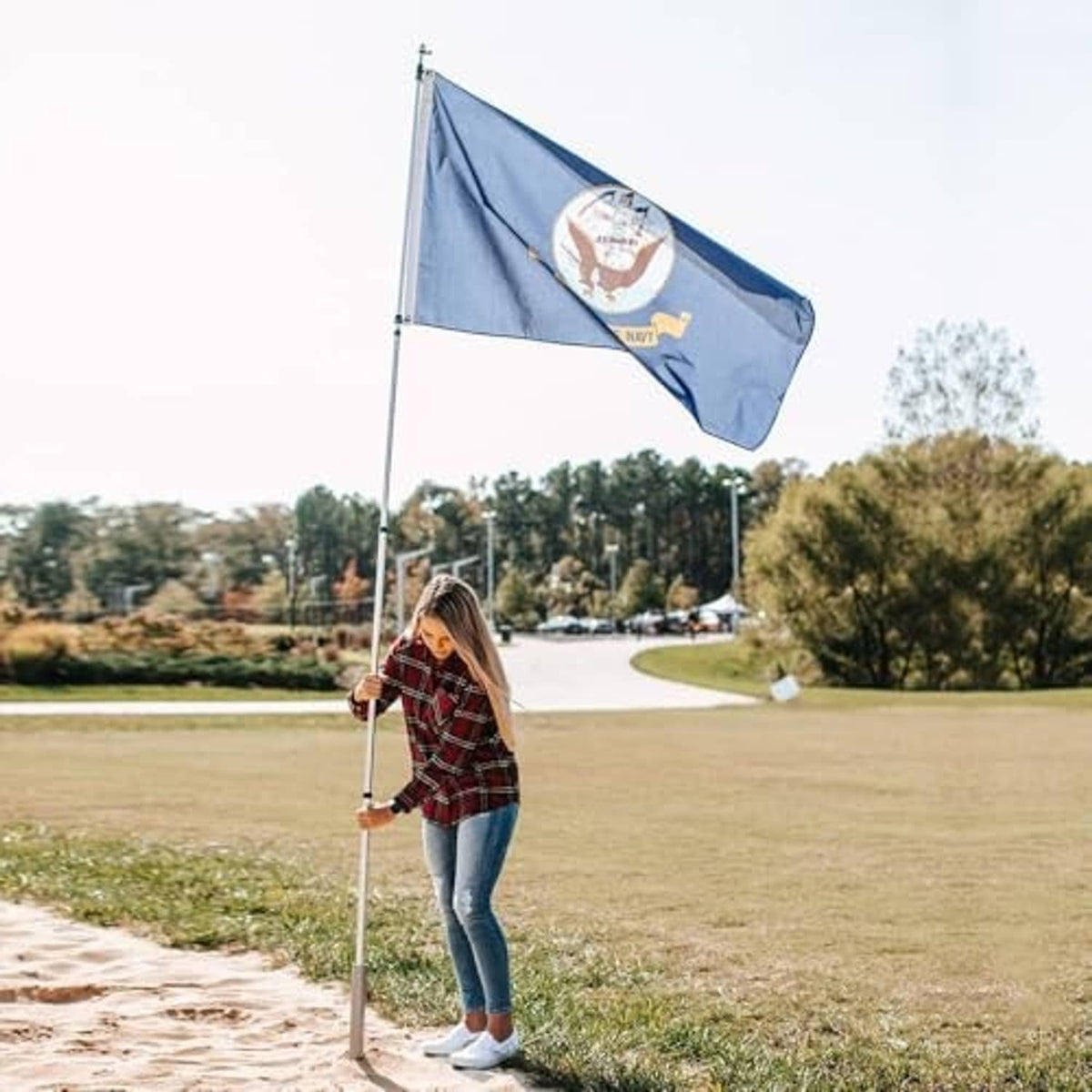 Portable flagpole with blue Flagpole To-Go banner flag on the telescoping pole