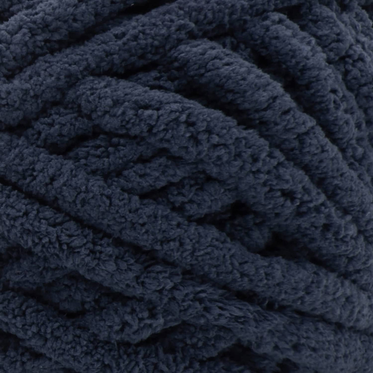 Dark indigo blue chenille yarn close-up with thick looped texture