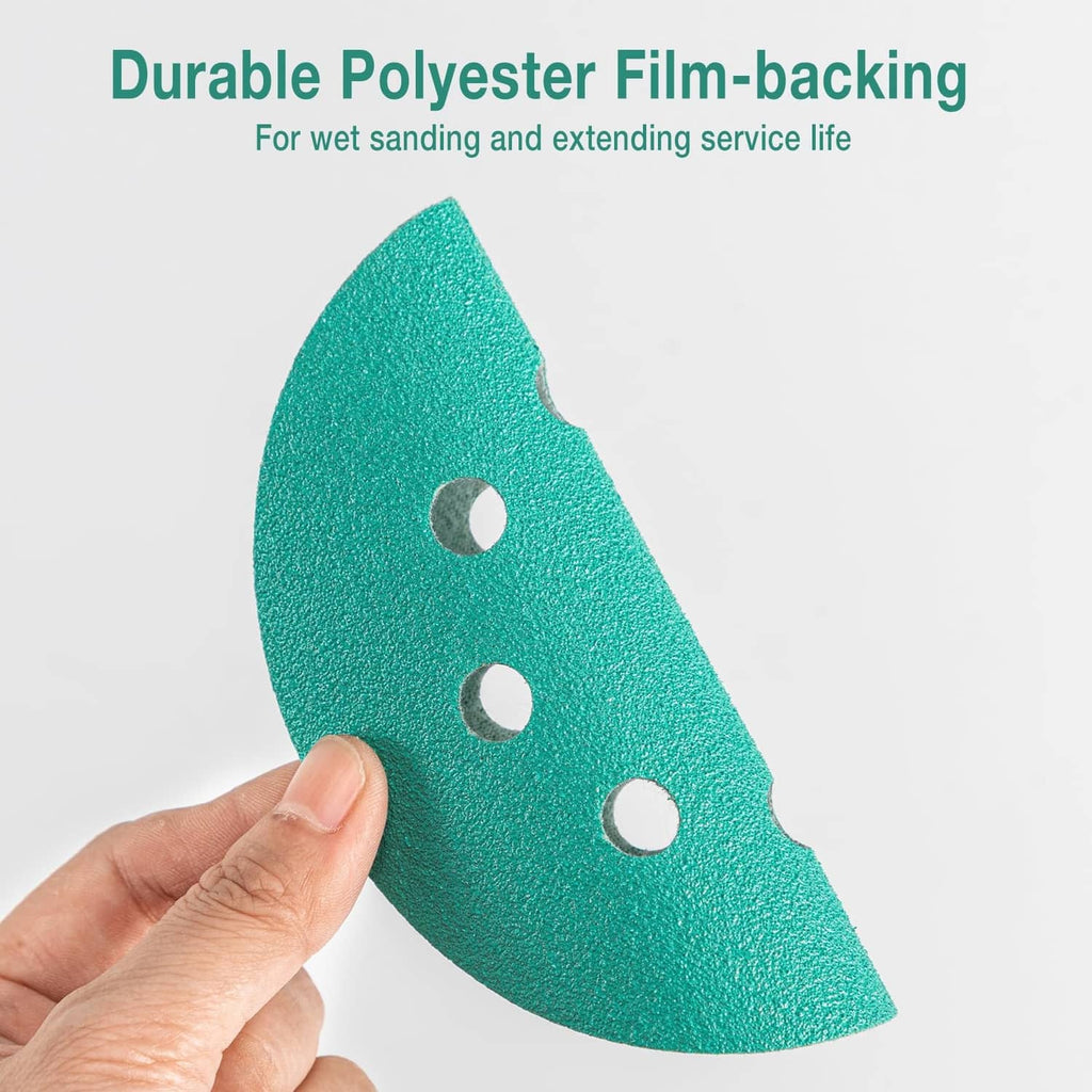 Single green 8-hole sanding disc held in hand, textured abrasive surface