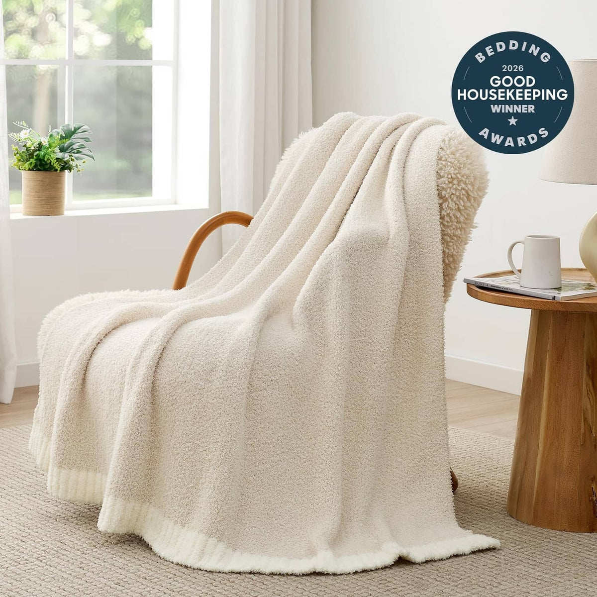 Ivory sherpa-style throw blanket draped over chair, thick plush texture
