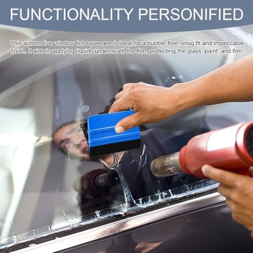 Blue felt-edge squeegee smoothing window tint film held in hand