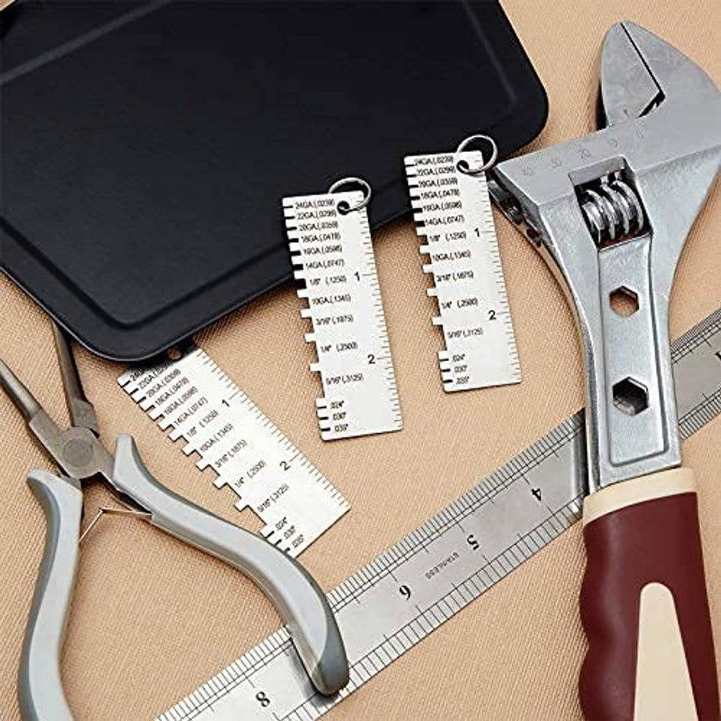 Metal wire thickness gauge tool with engraved scale on a workbench