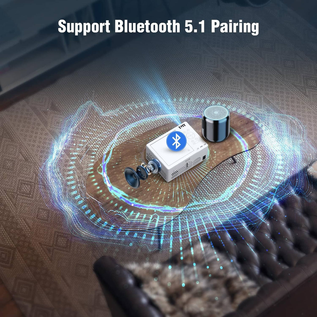 White mini projector with Bluetooth pairing accessory near projector lens