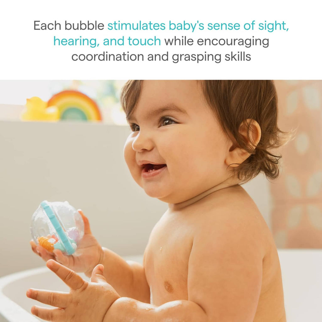 Baby splashing in bath while holding a clear bubble float toy