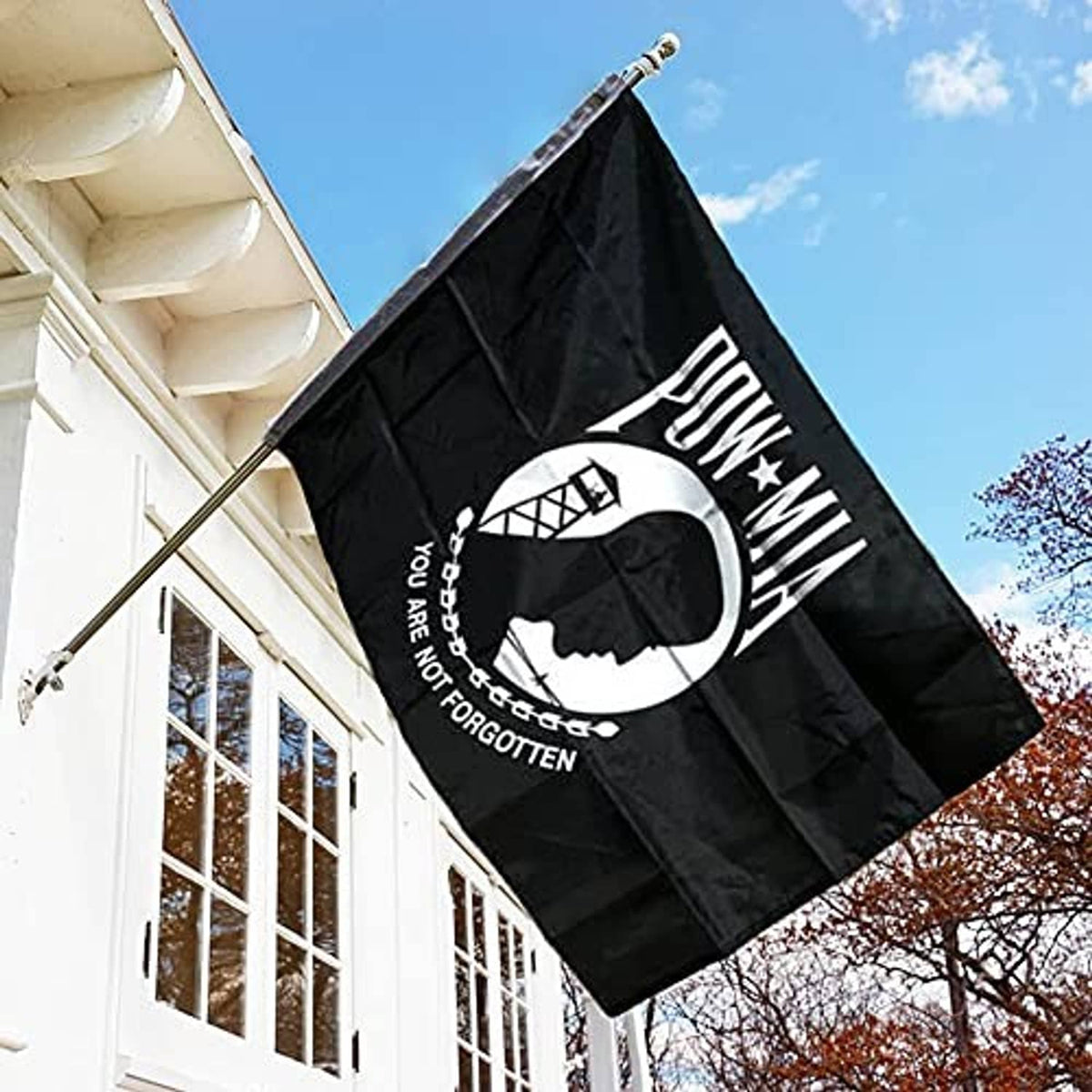 POW-MIA black double-sided outdoor flag with white emblem and text, flying on a pole