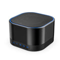 Portable white noise sound machine, black cylinder with blue-lit edge and speaker grille