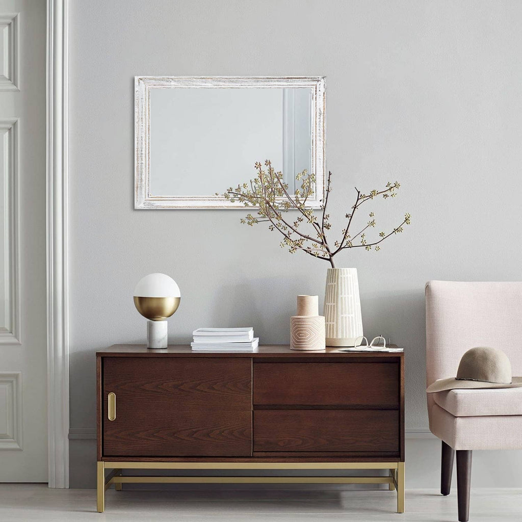 Wall-mounted rectangular mirror with distressed white frame and reflective glass