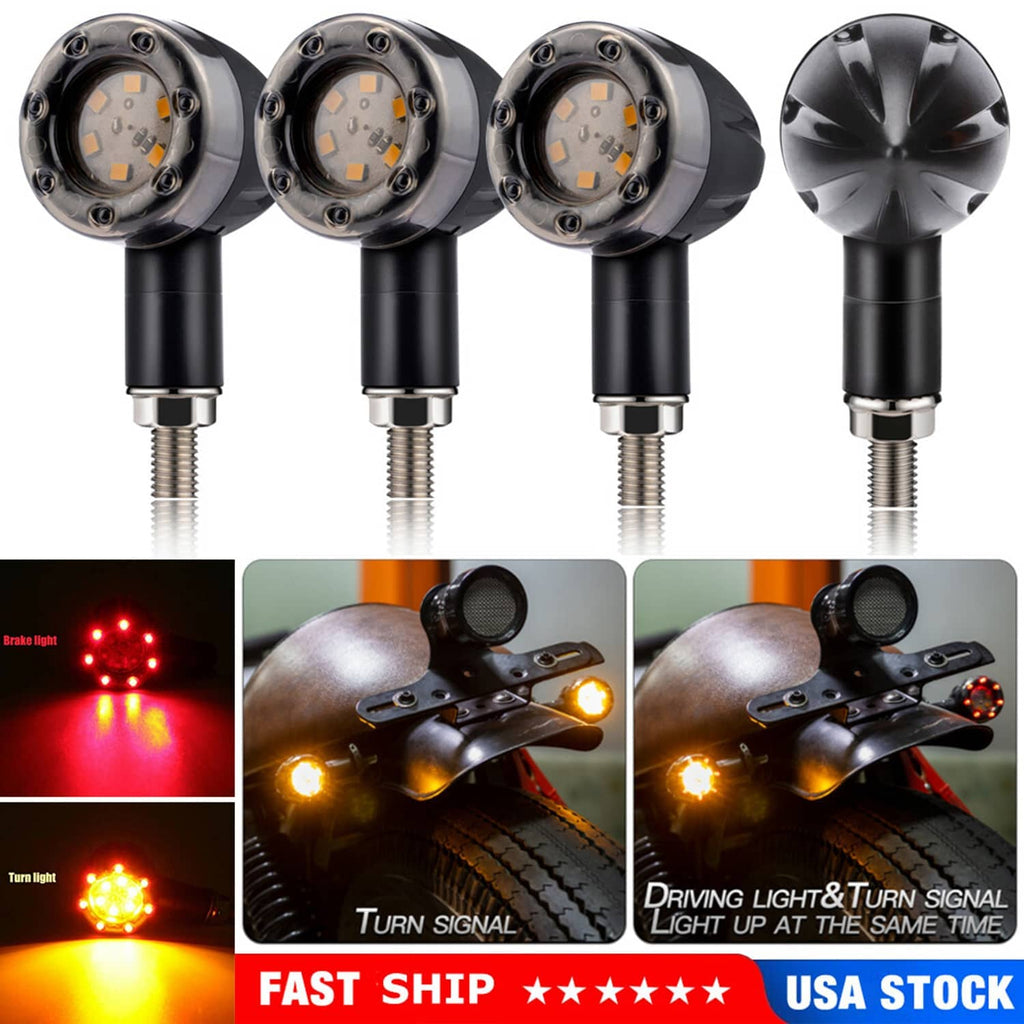 Four black LED motorcycle turn signal lights with clear lenses and glowing turn or running light effects