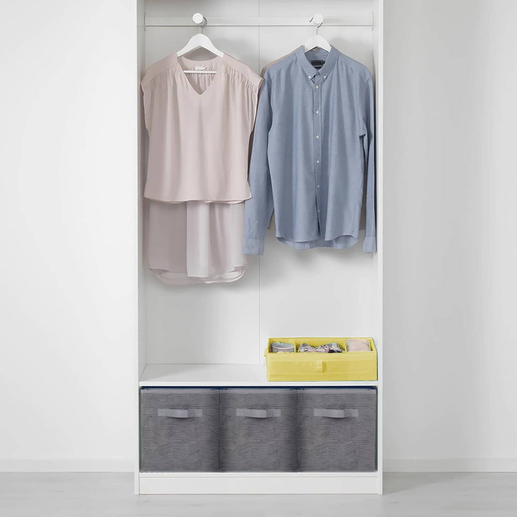 Open cabinet with dark gray fabric storage bins with black stripe pull tabs