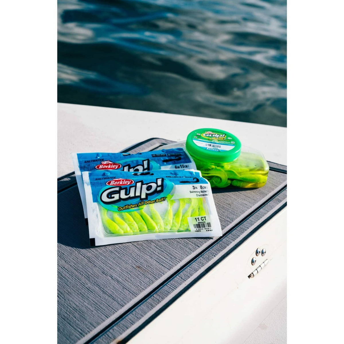 Gulp! soft bait pack and green container on a boat deck