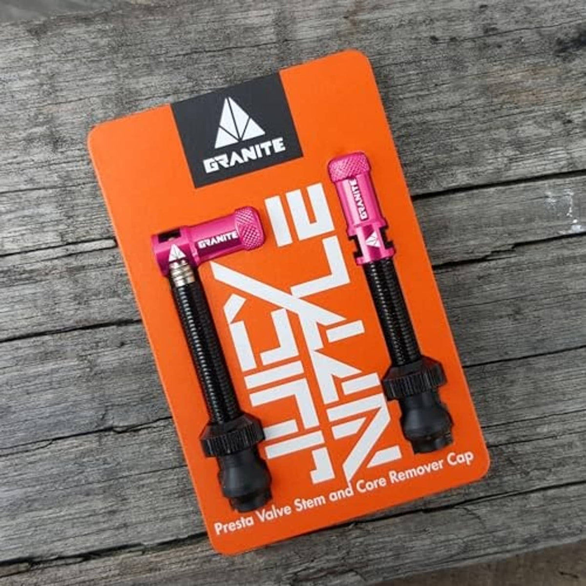 Presta valve stem and core remover caps set on orange retail card backing