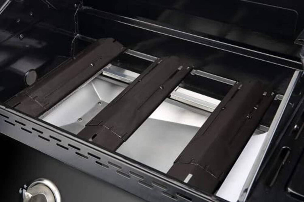 Black grill heat plate shield installed inside grill, showing vented slat panels