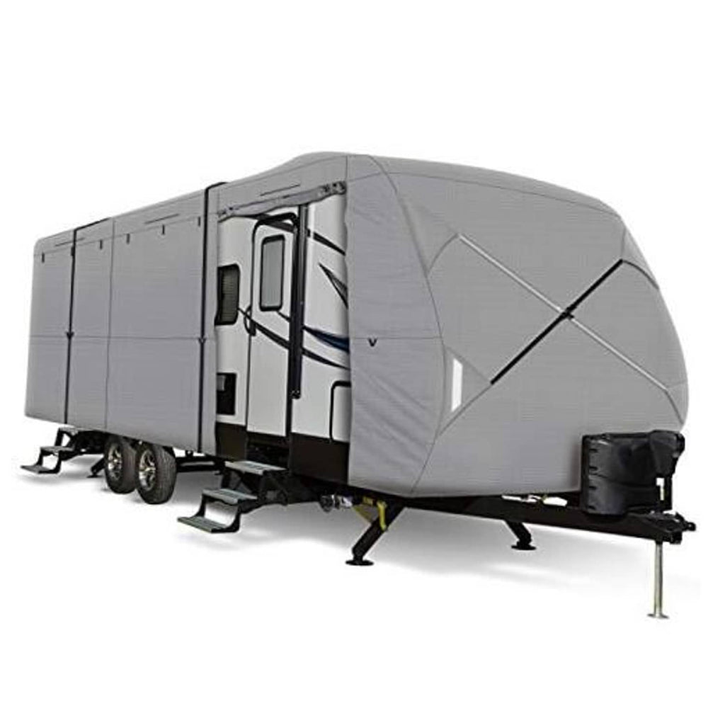 Grey travel trailer cover with cross-strap panel and front tie-down, side view