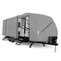 Grey travel trailer cover with cross-strap panel and front tie-down, side view