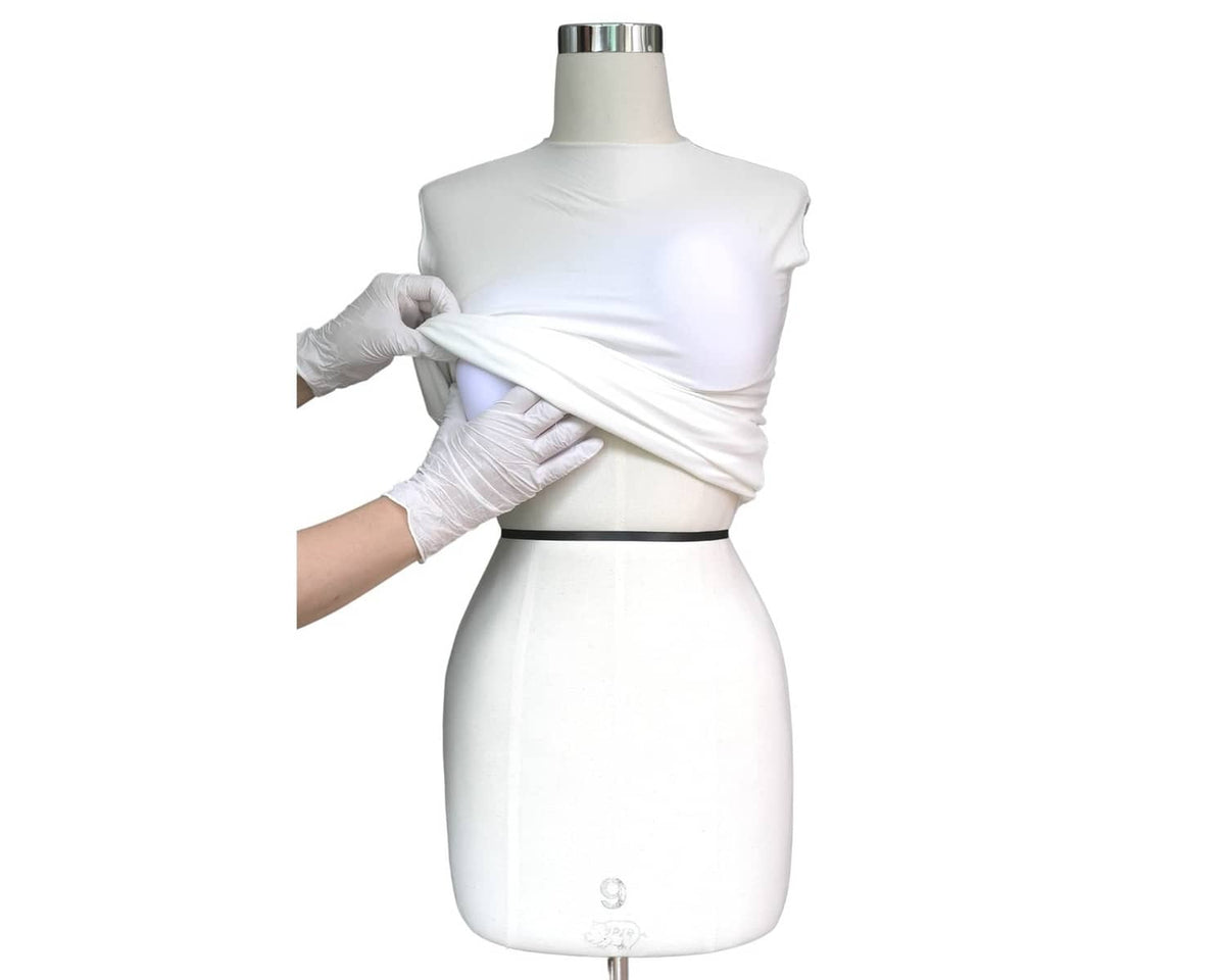 White stretch cover being wrapped around a dress form mannequin for padding setup